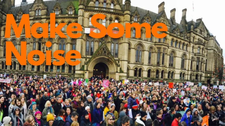 Photo of a crowd of protesters in front of Manchester Town Hall, with the caption Make Some Noise